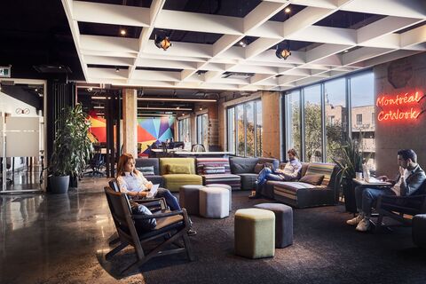 people sitting in a room with a large window