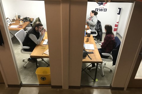 a group of people sitting at a table in a room