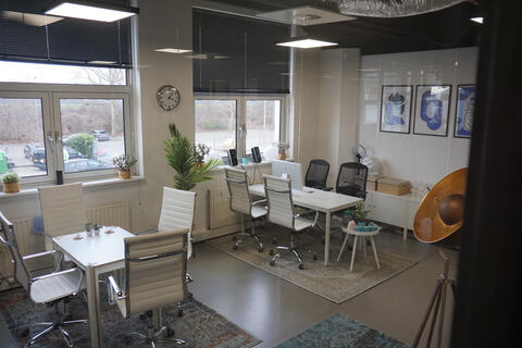 a room filled with furniture and a large window