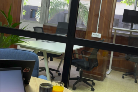 a laptop and two drinks on a table in an office