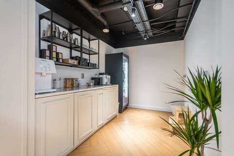 a kitchen area with a building in the background