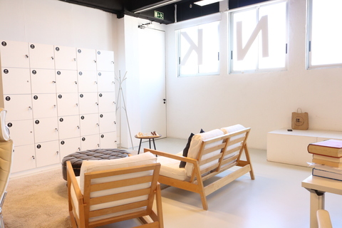 a bedroom with a bed and a chair in a room