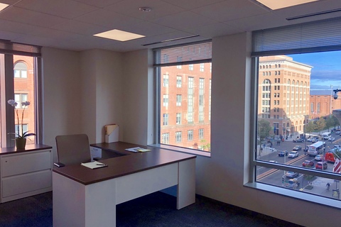 a room filled with furniture and a large window
