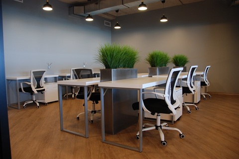 an office with a desk and chair in a room
