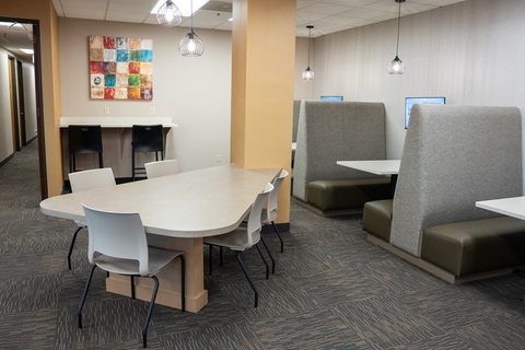 an office with a desk and chair in a room