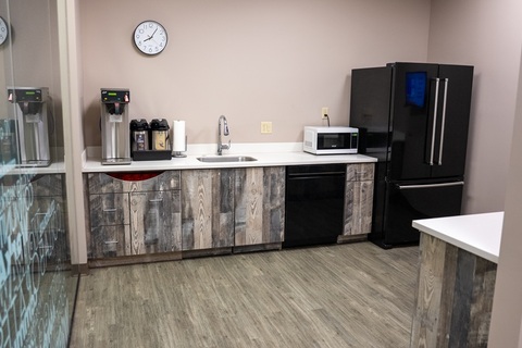 a large kitchen with stainless steel appliances and wooden cabinets