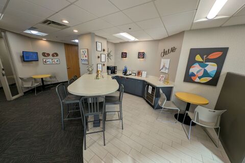 an office with a desk and chair in a room
