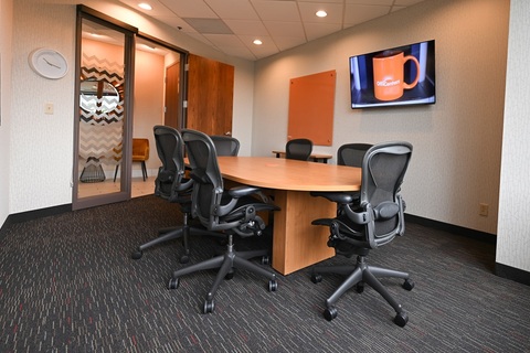 an office with a desk and chair in a room