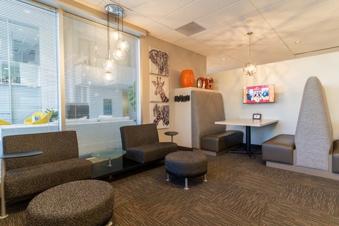 a living room filled with furniture and a large window