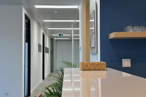 a white table with chairs in a hallway