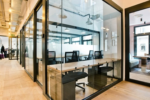 a room filled with furniture and a large window