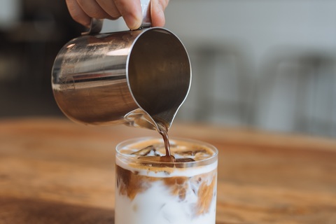 a close up of a person holding a cup