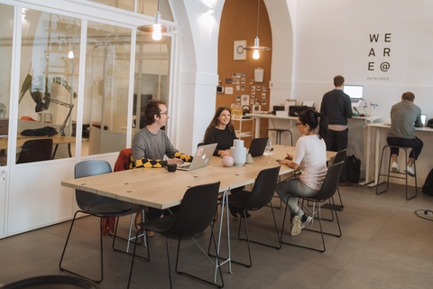 a group of people sitting at a table in a room