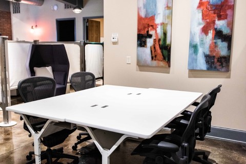an office with a desk and chair in a room