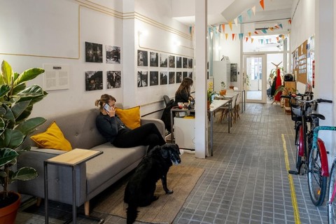 a person sitting in a living room with a bicycle