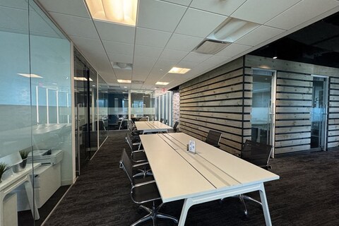 a room with a long table and chairs