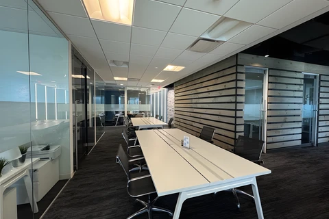 a room with a long table and chairs