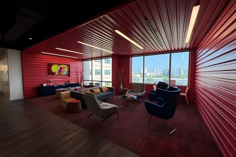 a room with red walls and a red wall with a couch and chairs