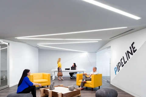 a group of people sitting in a room with large rocks