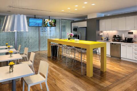 a kitchen with a table and chairs