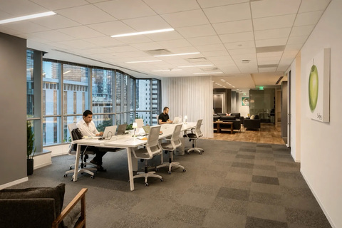 a group of people sitting at a table in an office