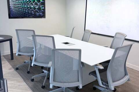 a conference room with a white board and chairs