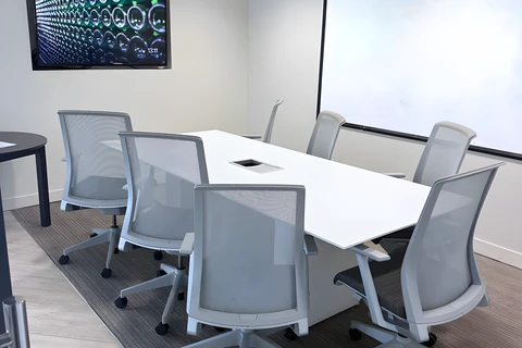 a conference room with a white board and chairs