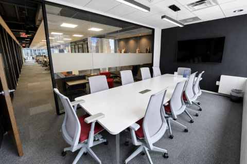 a conference room with a table and chairs