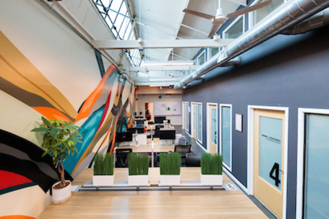 an office with a desk and chair in a room