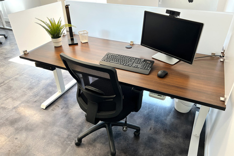 a desk with a computer and a chair
