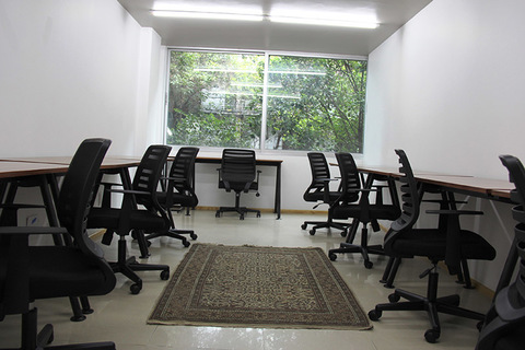 a living room filled with furniture and a large window