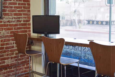 a chair sitting in front of a brick wall