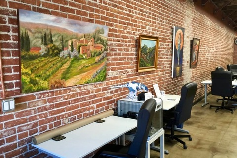 Beautiful artwork on exposed bricks throughout the coworking space with ergonomic chairs