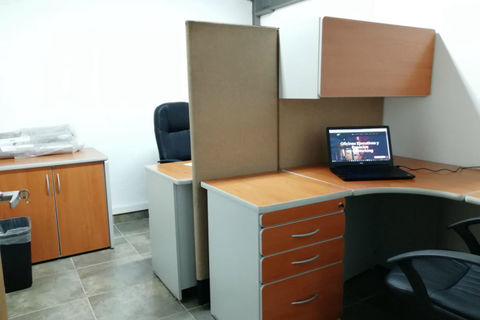a desk with a computer in an office