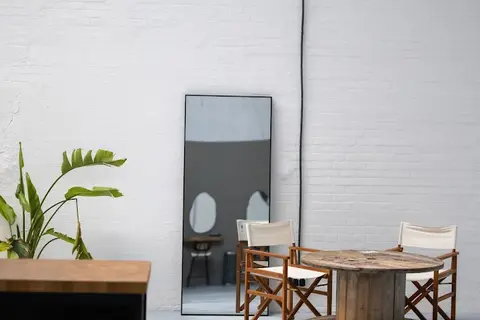 a room filled with furniture and vase of flowers on a table
