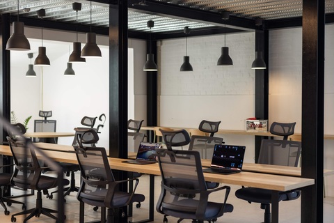 an office with a desk and chair in a room