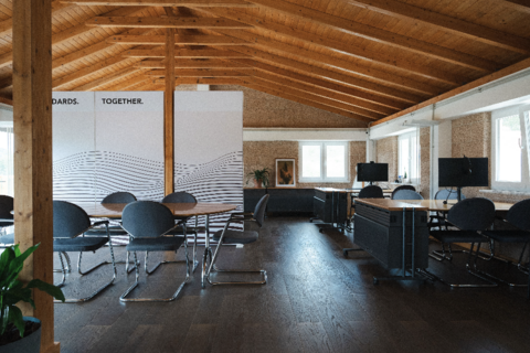 a room with a wood ceiling and a table and chairs