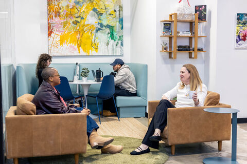 a group of people sitting around a living room