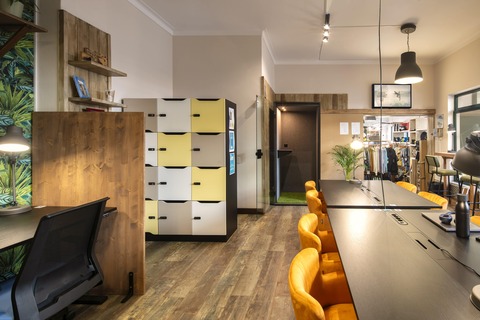 a kitchen area with a desk and chair in a room