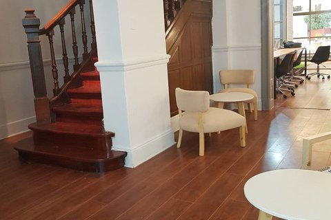 a living room filled with furniture on top of a hard wood floor