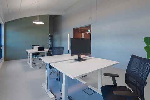 an office with a desk and chair in a room