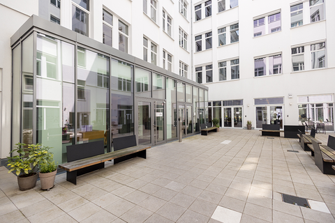 a building with glass walls and benches