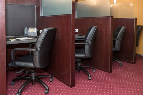 an office with a desk and chair in a room