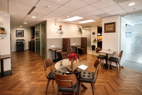 a room with a glass table and chairs