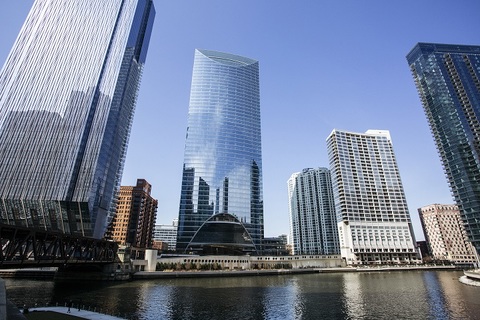 a bridge over a body of water with a city in the background