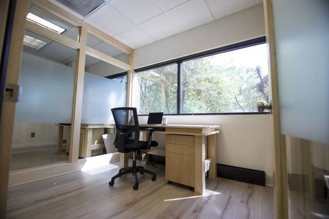 a room filled with furniture and a large window