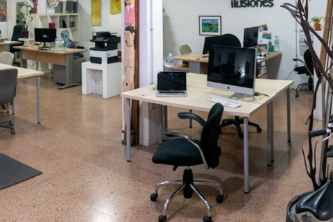 an office with a desk and chair in a room