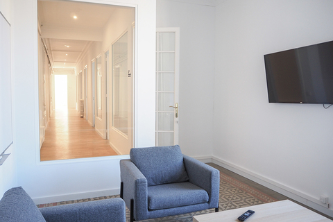 a living room filled with furniture and a large window