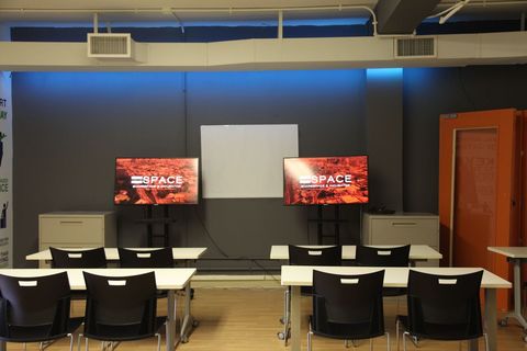 an office with a desk and chair in a room