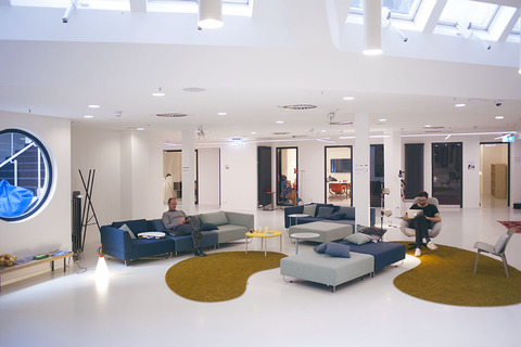 a living room filled with furniture and a large screen
